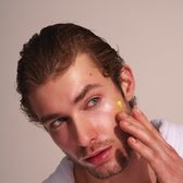 Applying PureDew Face Butter to the cheek