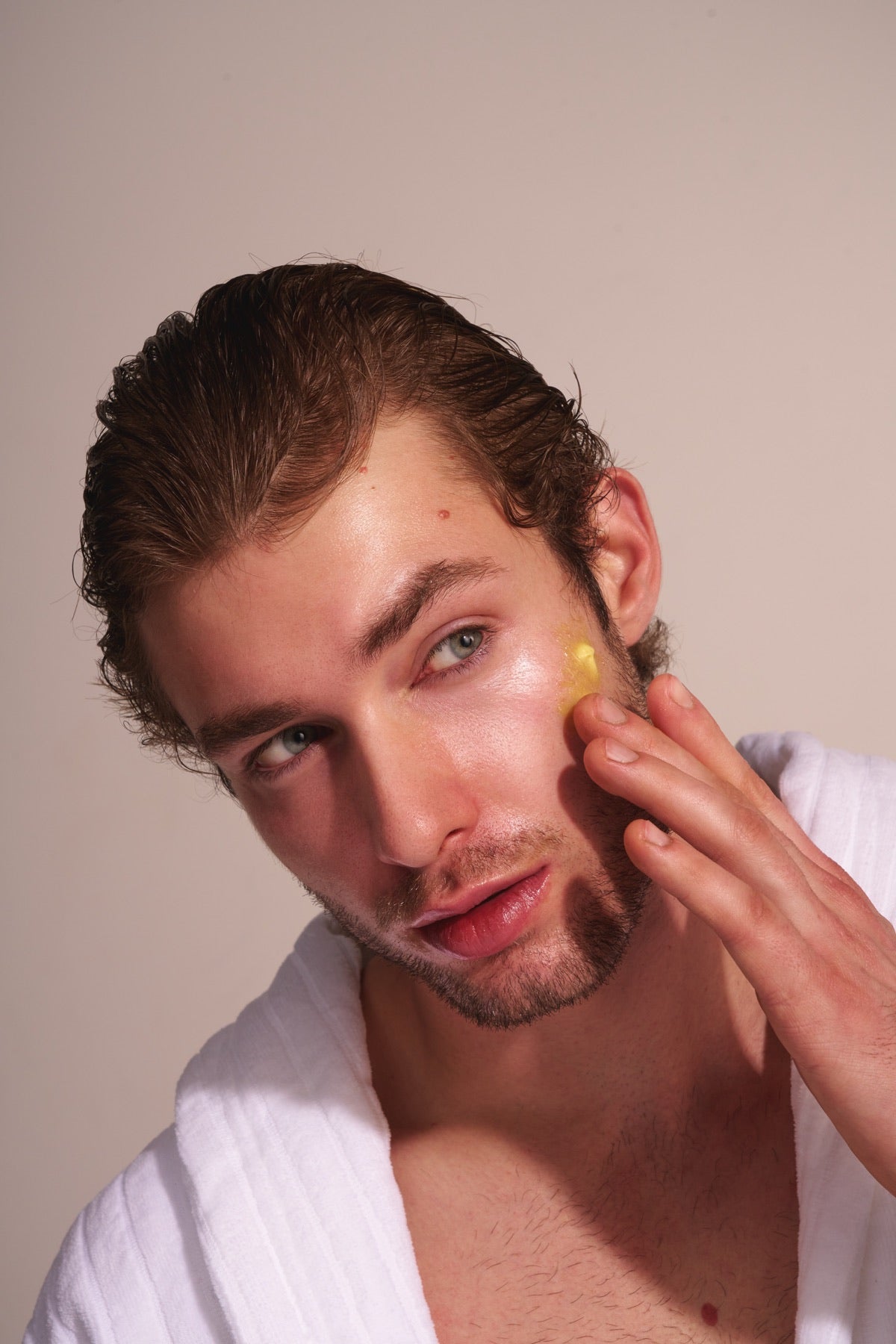 Applying PureDew Face Butter to the cheek